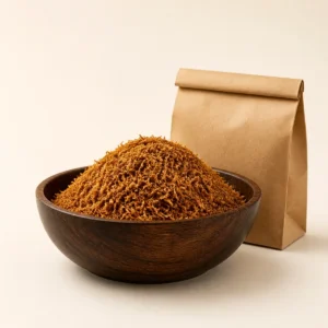 Premium loose tobacco in a wooden bowl beside a plain kraft pouch